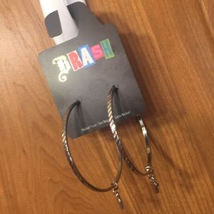 Large hoop earrings with tiny cross accent